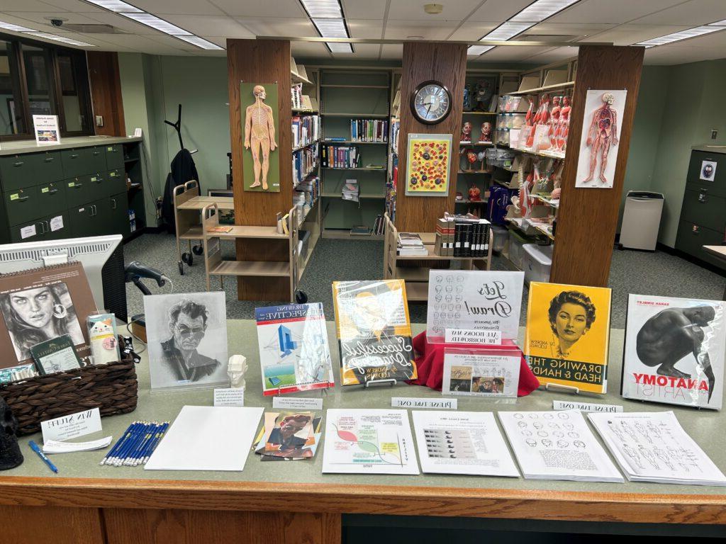 showing display of drawing books and instruction sheets at our circulation desk, with a gift basket to enter to win